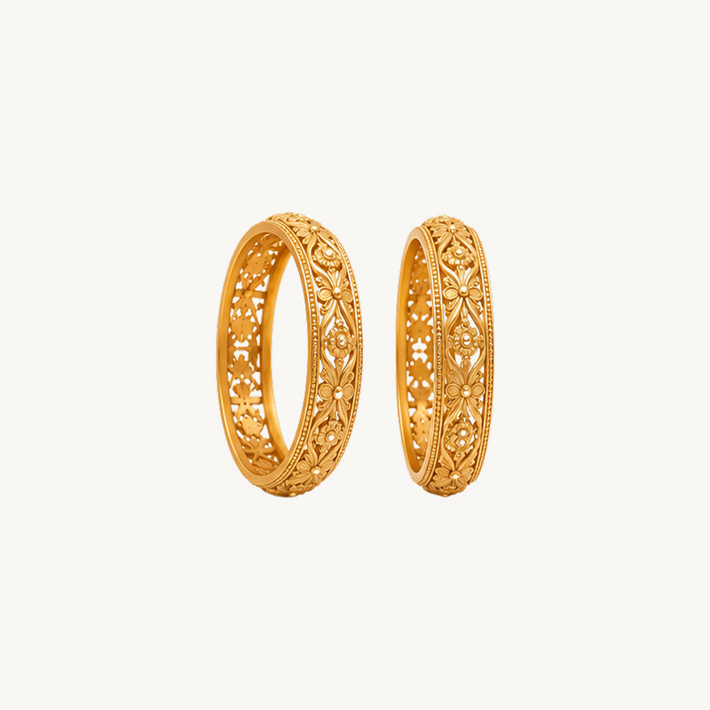 Golden floral trellis bangles shown upright at an angle